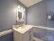 Charming bathroom with white vanity and updated fixtures at 7169 Pleasant Grove Rd, Charlotte, NC 28216