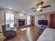 Relaxing bedroom with hardwood floors and fireplace at 7169 Pleasant Grove Rd, Charlotte, NC 28216
