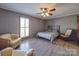 Comfortable bedroom with hardwood floors and a rocking chair at 7169 Pleasant Grove Rd, Charlotte, NC 28216