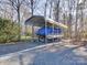 Metal carport providing covered parking for a boat at 7169 Pleasant Grove Rd, Charlotte, NC 28216