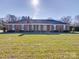 Attractive brick home with blue shutters, manicured lawn, and a welcoming entrance at 7169 Pleasant Grove Rd, Charlotte, NC 28216