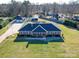Expansive brick home featuring a large yard, detached garage, and mature trees at 7169 Pleasant Grove Rd, Charlotte, NC 28216