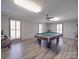 Game room with pool table, exercise bike, and hardwood floors at 7169 Pleasant Grove Rd, Charlotte, NC 28216