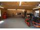 Large open garage interior featuring a workbench, tool storage, and various equipment at 7169 Pleasant Grove Rd, Charlotte, NC 28216