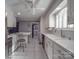 Bright kitchen with white cabinets, stainless steel appliances, and an island at 7169 Pleasant Grove Rd, Charlotte, NC 28216