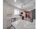 Modern kitchen with white cabinets, stainless steel appliances, and breakfast bar at 7169 Pleasant Grove Rd, Charlotte, NC 28216