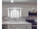 White kitchen with stainless steel appliances and large sink at 7169 Pleasant Grove Rd, Charlotte, NC 28216