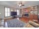 Spacious living room features a brick fireplace, built-in shelving, and hardwood floors at 7169 Pleasant Grove Rd, Charlotte, NC 28216
