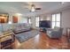 Spacious living room with hardwood floors, comfortable seating and large TV at 7169 Pleasant Grove Rd, Charlotte, NC 28216