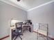 Home office with corner desk and chair at 7169 Pleasant Grove Rd, Charlotte, NC 28216