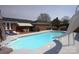 Sparkling pool with a slide and lounge area, perfect for outdoor relaxation and entertaining at 7169 Pleasant Grove Rd, Charlotte, NC 28216