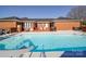 Backyard swimming pool with slide, brick patio, outdoor dining set and grill at 7169 Pleasant Grove Rd, Charlotte, NC 28216