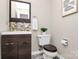 Updated half bathroom with dark vanity and modern tile backsplash at 1061 Fairway Ridge Rd, Concord, NC 28027