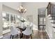 Charming dining area with hardwood floors and a glass-top dining table at 1061 Fairway Ridge Rd, Concord, NC 28027