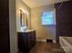 Bathroom with vanity, tub and tiled walls at 1103 Sunset Dr, Kannapolis, NC 28081