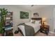 Bedroom with a twin bed, wooden nightstand, and nature prints at 11231 Heritage Green Dr, Cornelius, NC 28031