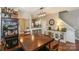 Spacious dining area with a large wooden table and kitchen views at 11231 Heritage Green Dr, Cornelius, NC 28031
