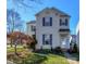 Two-story house with light beige siding, gray shutters, and a landscaped front yard at 11231 Heritage Green Dr, Cornelius, NC 28031