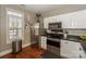 Modern kitchen with stainless steel appliances and wood floors at 11231 Heritage Green Dr, Cornelius, NC 28031