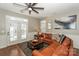 Living area features a brown leather sectional and a large window at 11231 Heritage Green Dr, Cornelius, NC 28031