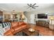 Open concept living room with a comfortable leather couch and media console at 11231 Heritage Green Dr, Cornelius, NC 28031
