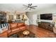 Open living space showcasing a brown leather sectional and hardwood floors at 11231 Heritage Green Dr, Cornelius, NC 28031