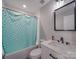 Clean bathroom with teal shower curtain and white vanity at 114 W Lee Ave, Bessemer City, NC 28016