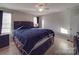 Primary bedroom with dark wood bed frame and ceiling fan at 114 W Lee Ave, Bessemer City, NC 28016