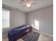 Bright bedroom with a dark-blue comforter and ceiling fan at 114 W Lee Ave, Bessemer City, NC 28016