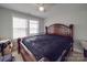 Spacious bedroom with a dark wood bed frame and ceiling fan at 114 W Lee Ave, Bessemer City, NC 28016