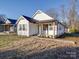 White house with teal front door, and walkway at 114 W Lee Ave, Bessemer City, NC 28016