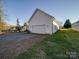 Detached garage with gravel driveway and grassy yard at 114 W Lee Ave, Bessemer City, NC 28016