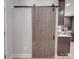 Gray barn door adds rustic charm to this home's interior at 114 W Lee Ave, Bessemer City, NC 28016