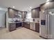 Modern kitchen with stainless steel appliances and dark cabinets at 114 W Lee Ave, Bessemer City, NC 28016