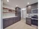 Modern kitchen with dark cabinets, stainless steel appliances, and white countertops at 114 W Lee Ave, Bessemer City, NC 28016