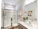 Clean bathroom with a walk-in shower, modern vanity, and window at 1467 Honey Trl, Monroe, NC 28112