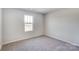 Simple bedroom with a window and neutral colored carpet at 1467 Honey Trl, Monroe, NC 28112