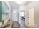 Bright entryway with hardwood floors, coat closet and view into bedroom at 1467 Honey Trl, Monroe, NC 28112