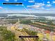 Aerial view of neighborhood amenities, including a pool and lake at 15298 Windward Ln, Lancaster, SC 29720