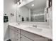 Modern bathroom featuring double vanity with white countertop and large mirror reflecting a glass-enclosed shower at 15298 Windward Ln, Lancaster, SC 29720