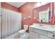 Cozy bathroom featuring a single vanity, toilet, and a shower with a decorative curtain at 15298 Windward Ln, Lancaster, SC 29720