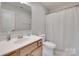 Clean bathroom featuring a single vanity, toilet, and a shower with a decorative curtain at 15298 Windward Ln, Lancaster, SC 29720