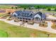 Aerial shot of a modern, black and white clubhouse with stone accents and beautifully landscaped grounds at 15298 Windward Ln, Lancaster, SC 29720