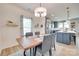 Elegant dining room with modern lighting and an open view to the kitchen, perfect for entertaining at 15298 Windward Ln, Lancaster, SC 29720