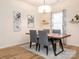 Modern dining room features a wood table with grey chairs and hardwood floors at 15298 Windward Ln, Lancaster, SC 29720