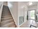 Welcoming entryway with staircase, stylish gray wainscoting, and an open door to the outside at 15298 Windward Ln, Lancaster, SC 29720