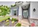 Inviting front porch with stone accents and a well-maintained garden, adding to the home's curb appeal at 15298 Windward Ln, Lancaster, SC 29720