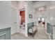 Bright hallway with a glimpse of the kitchen and a stylish bench, enhancing the home's modern appeal at 15298 Windward Ln, Lancaster, SC 29720