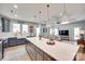 Spacious open-concept kitchen with island seating and modern appliances, seamlessly connecting to the living area at 15298 Windward Ln, Lancaster, SC 29720