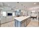 Open-concept kitchen boasts a large island with white countertops and adjacent living and dining areas at 15298 Windward Ln, Lancaster, SC 29720